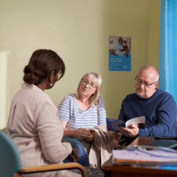 Man and woman speaking to medical professional