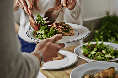 Person serving food to another person